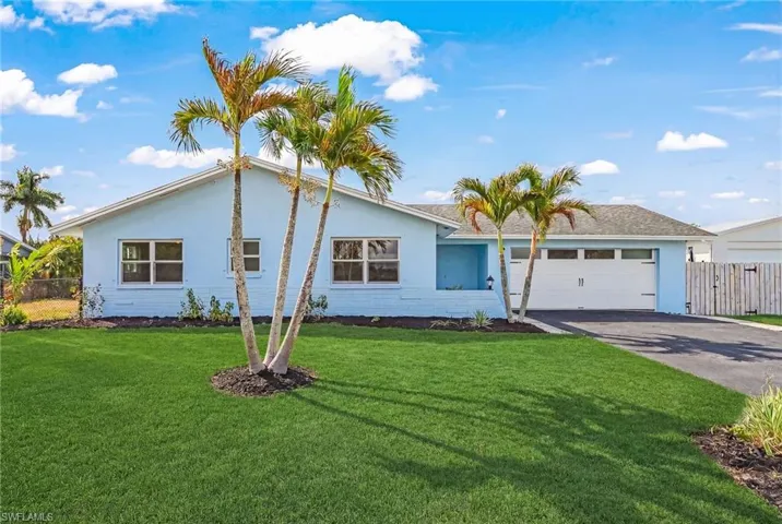 Ranch-style house with stucco siding, driveway, and an attached garage