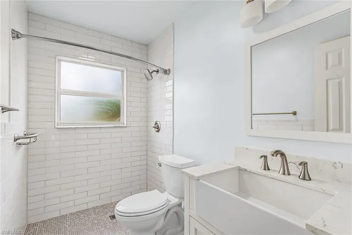 Full bathroom with vanity and a shower stall
