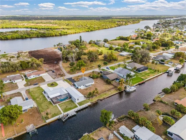 Aerial view of residential area featuring a nearby body of water