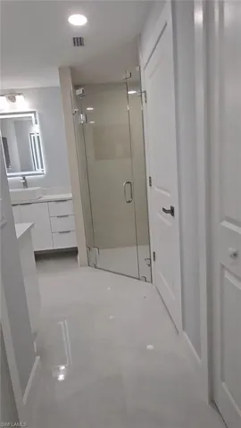 Full bath featuring vanity, a shower stall, and recessed lighting