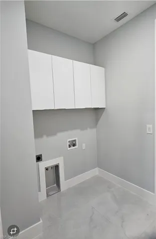 Laundry area featuring washer hookup, hookup for an electric dryer, and cabinet space