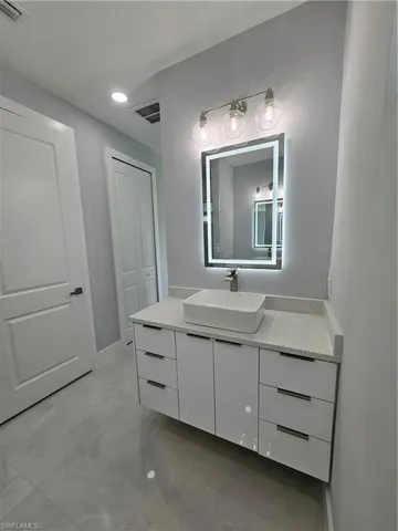 Bathroom featuring vanity and baseboards
