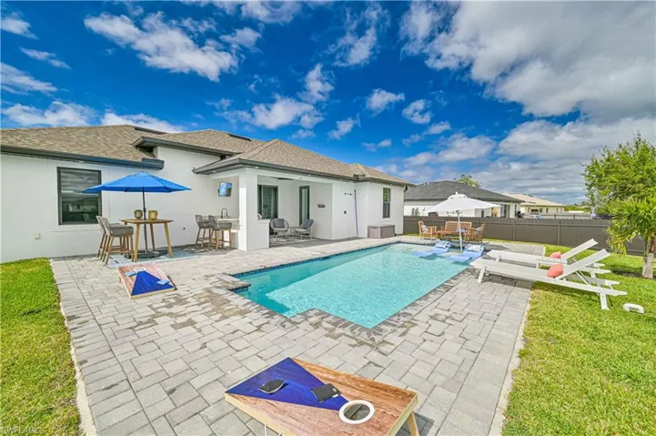 View of swimming pool featuring a fenced in pool, outdoor dining area, fence, and a patio