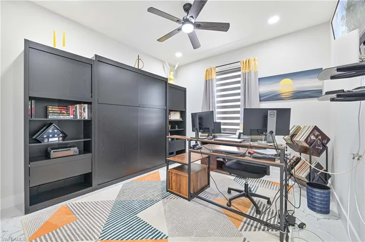 Home office with marble finish floor, a ceiling fan, and recessed lighting