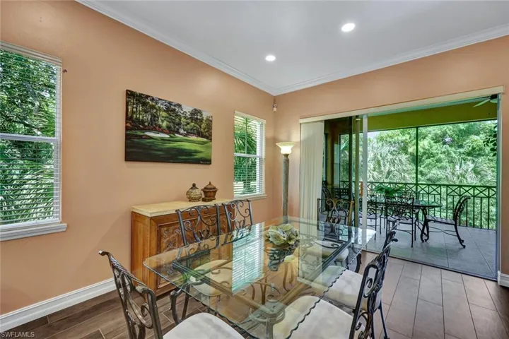 Dining room featuring wood tiled floors, ornamental molding, and recessed lighting
