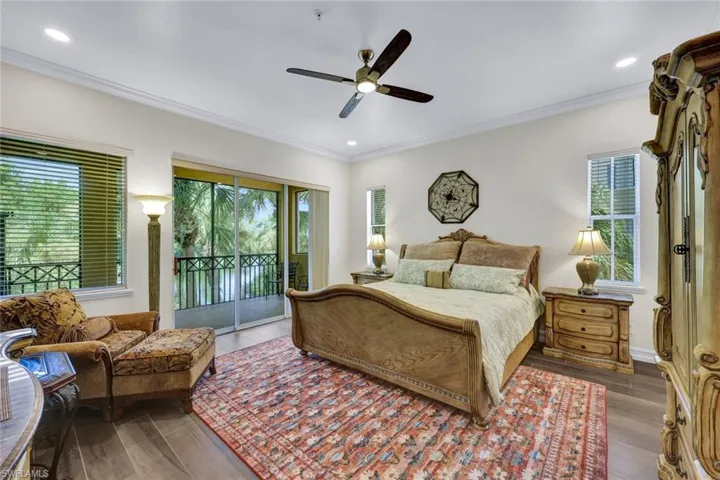 Bedroom featuring crown molding, access to exterior, wood finished floors, recessed lighting, and ceiling fan