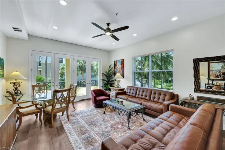 Living area featuring french doors, ceiling fan, wood-type flooring, and recessed lighting