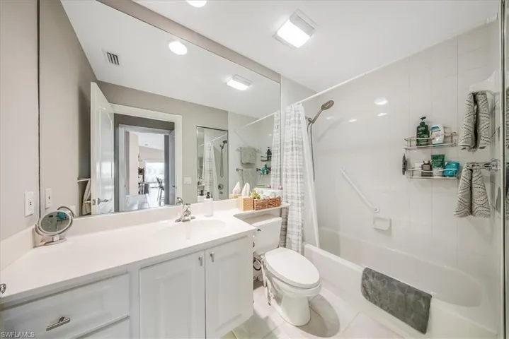White vanity with integrated sink and chrome faucet