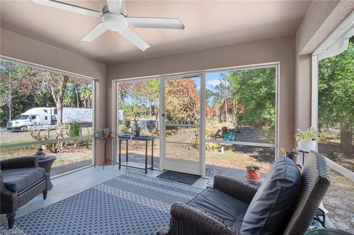 Sunroom featuring ceiling fan and healthy amount of natural light