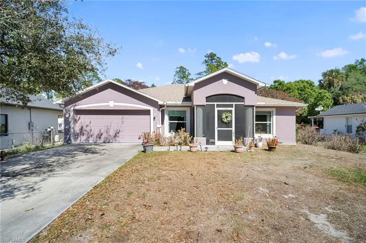 Ranch-style house featuring an attached garage, driveway, and stucco siding