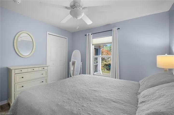 Bedroom with ceiling fan and a closet