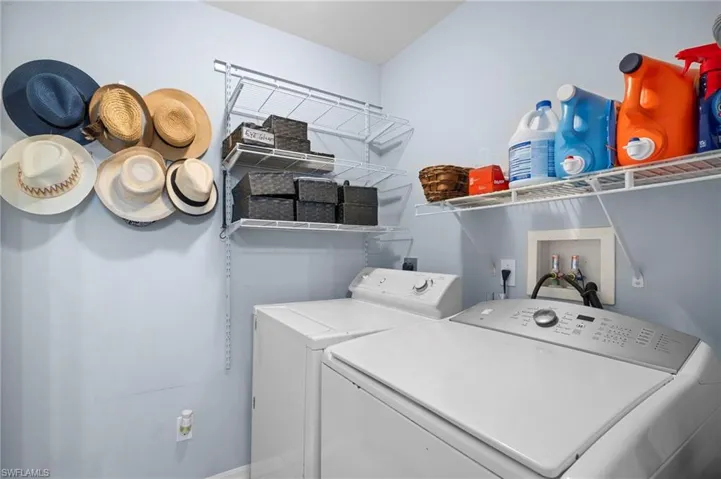 Laundry area with washer and dryer and baseboards