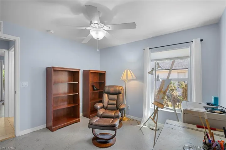 Sitting room with baseboards and ceiling fan