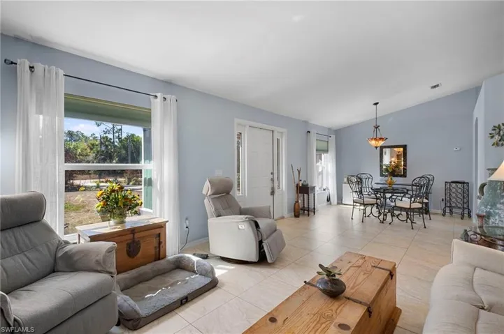 Living room with lofted ceiling and baseboards