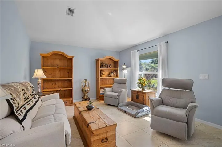 Living area featuring baseboards and light tile patterned floors