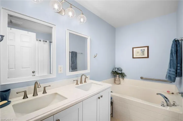 Full bath with double vanity and a bath
