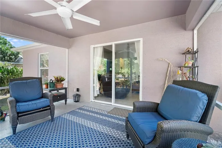 View of patio with ceiling fan and outdoor furniture