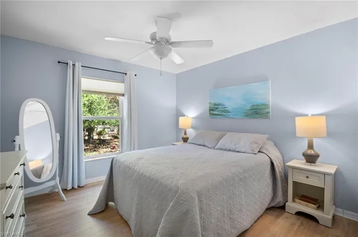 Bedroom with light wood finished floors and ceiling fan