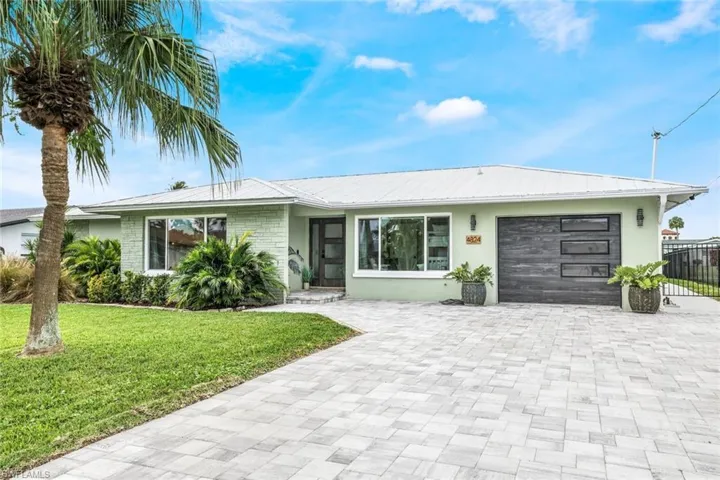 Ranch-style home with a garage and a front yard
