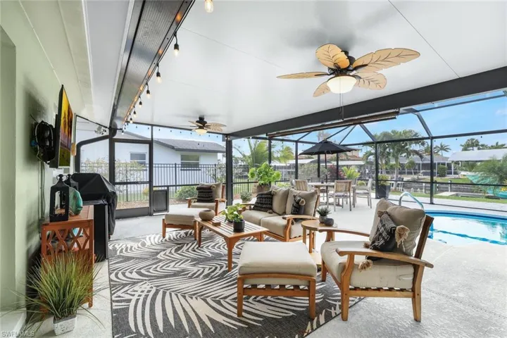 Sunroom with ceiling fan and a pool