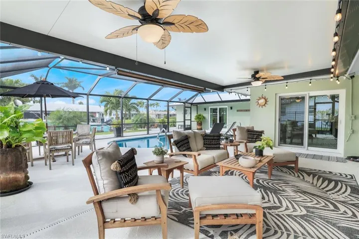 View of patio / terrace with glass enclosure, ceiling fan, and an outdoor hangout area