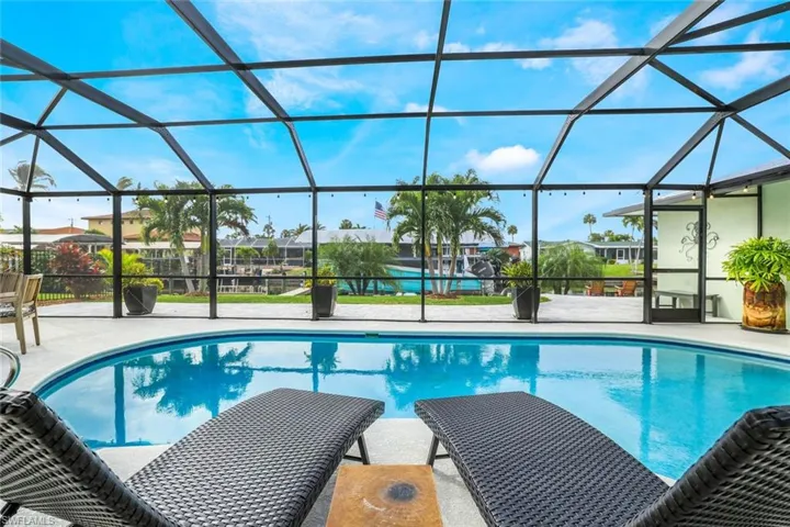 View of swimming pool with a lanai and a patio area