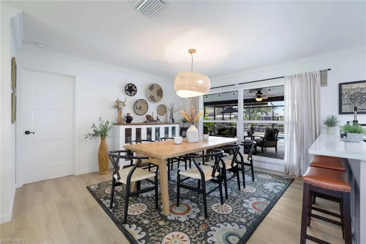 Dining area featuring crown molding, ceiling fan, and light hardwood / wood-style floors