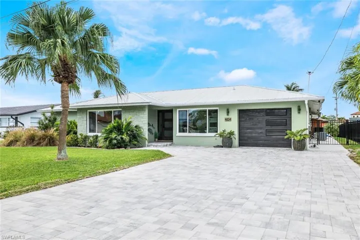 Ranch-style house with a garage and a front yard