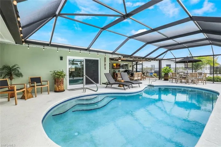 View of pool with a lanai and a patio area