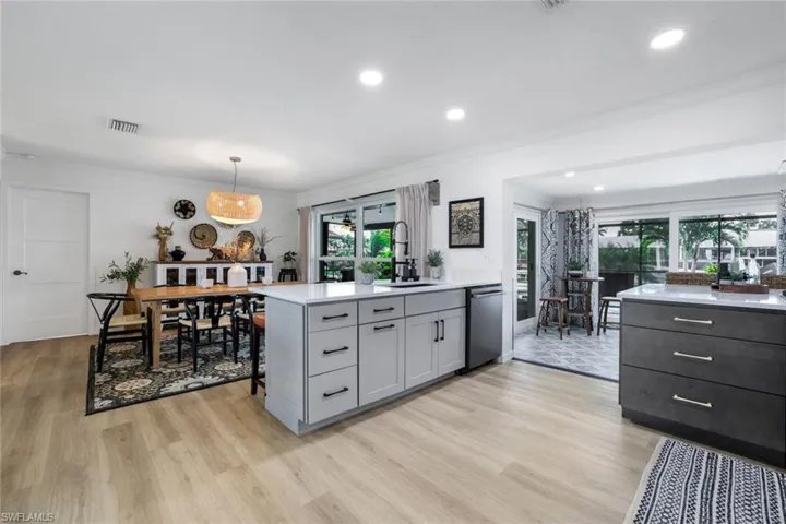 Kitchen featuring dishwasher, sink, gray cabinetry, and light hardwood / wood-style floors