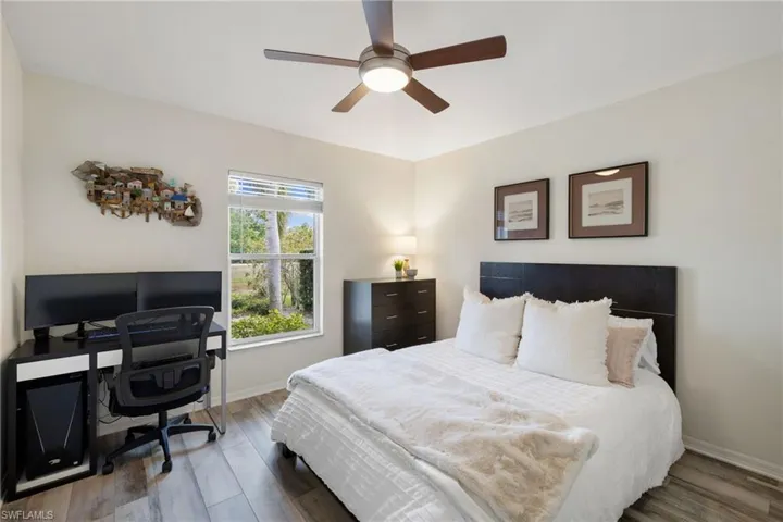Bedroom featuring a ceiling fan, dark wood finished floors, and baseboards
