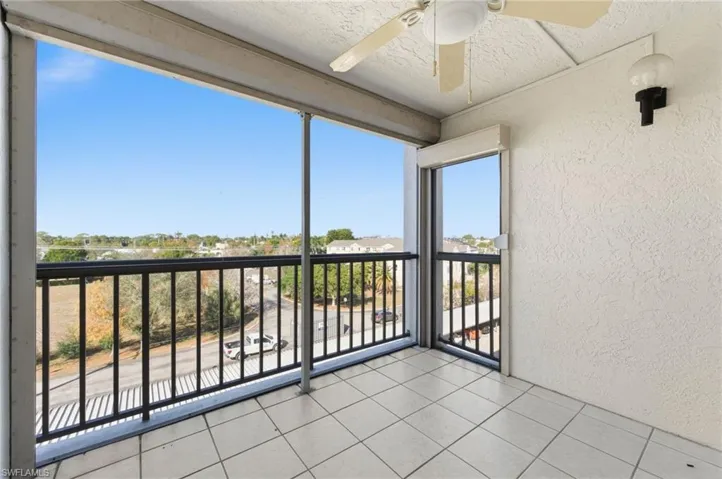 Unfurnished sunroom with a textured wall, tile patterned floors, and a textured ceiling