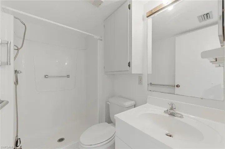 Full bathroom featuring a stall shower and vanity