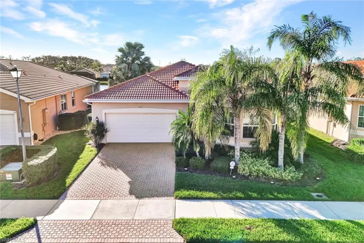 Mediterranean / spanish home with a front lawn and a garage