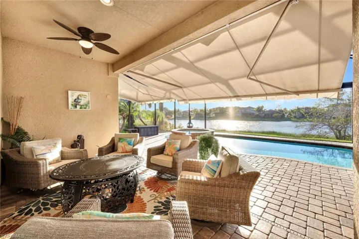 View of patio / terrace featuring an outdoor living space, ceiling fan, and a water view