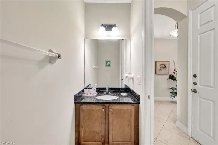 Bathroom with tile patterned floors and vanity