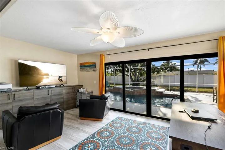 Living room with ceiling fan and light wood-type flooring