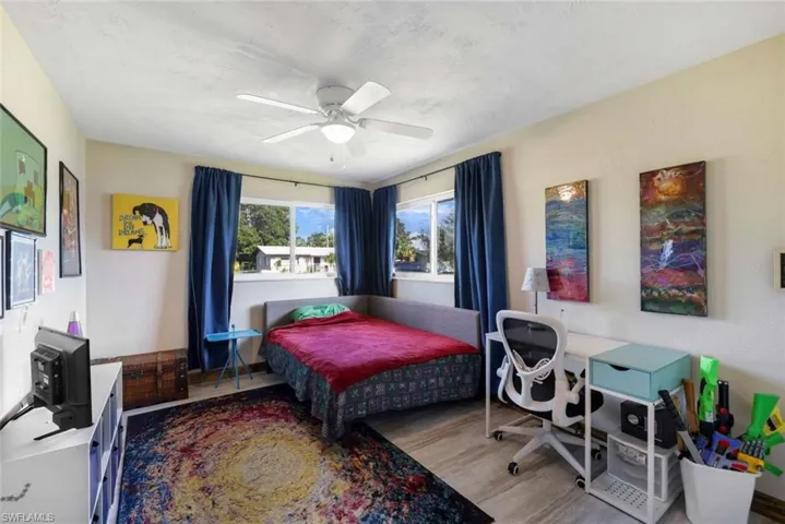 Bedroom featuring ceiling fan and hardwood / wood-style floors