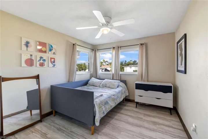 Bedroom with ceiling fan and hardwood / wood-style flooring