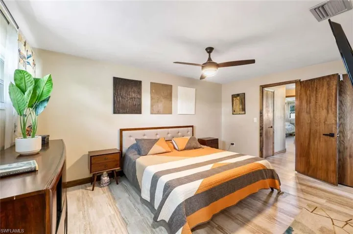 Bedroom with ceiling fan and light hardwood / wood-style flooring