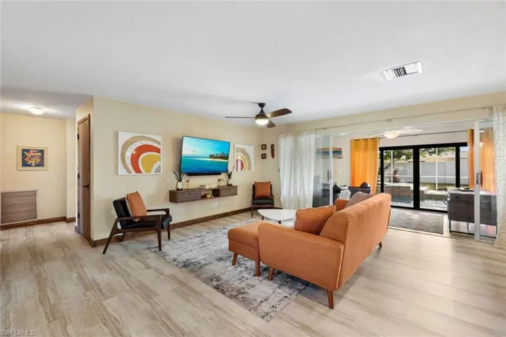 Living room featuring ceiling fan and light hardwood / wood-style flooring