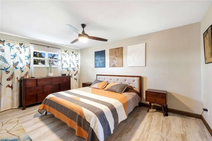 Bedroom with ceiling fan and light wood-type flooring