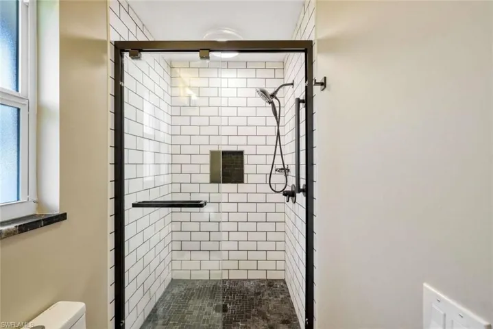 Bathroom featuring walk in shower and toilet