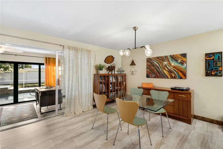 Dining room with a notable chandelier and light wood-type flooring