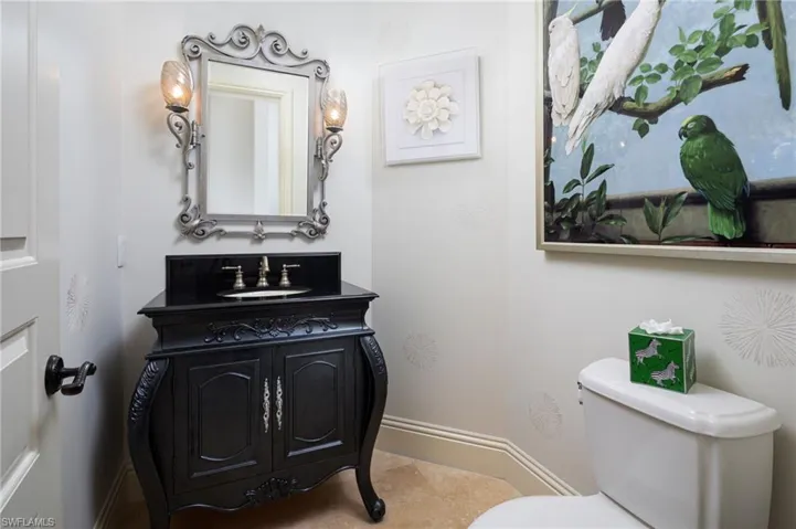 Half bathroom featuring vanity and toilet