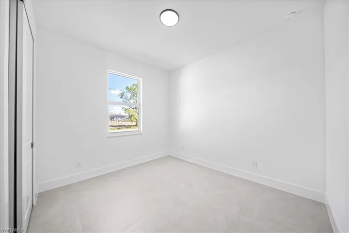 Empty room featuring baseboards