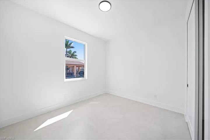Empty room featuring baseboards