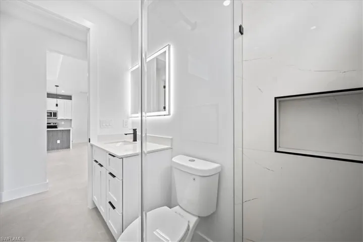Full bath with toilet and vanity
