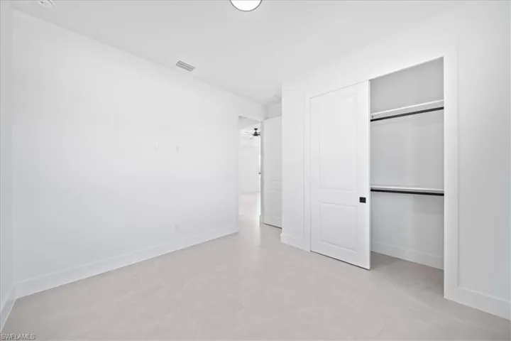 Unfurnished bedroom with baseboards and a closet