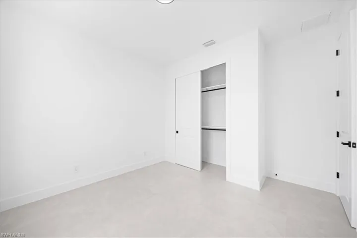 Unfurnished bedroom with baseboards and a closet